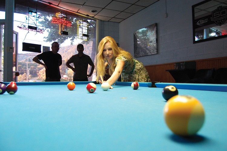 Alanna uses a public, less expensive P&J Billiards cue at P&J Billiards. - PHOTO BY ANDREW GOFF