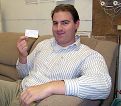 Anthony Mantova, of Carlotta, ohlds a Barack Obama business card from his days as a U.S. Senator. Photo by Ryan Burns