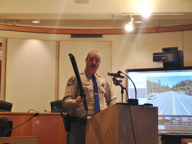 California Highway Patrol Capt. Adam Jager holds a machete similar to the one officials say a 17-year-old suspect used to attack an officer yesterday, leading to a fatal shooting. - THADEUS GREENSON