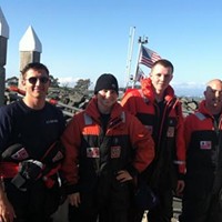 Coast Guard Station Humboldt Bay rescue crew members, from left, Seaman Noah Perry, Petty Officer 2nd Class Torre Taylor, Seaman Jacob Roberds, and Petty Officer 2nd Class Louis Ciccoli, pause for a photo after saving two fishermen from the surf after a wave overturned their boat.