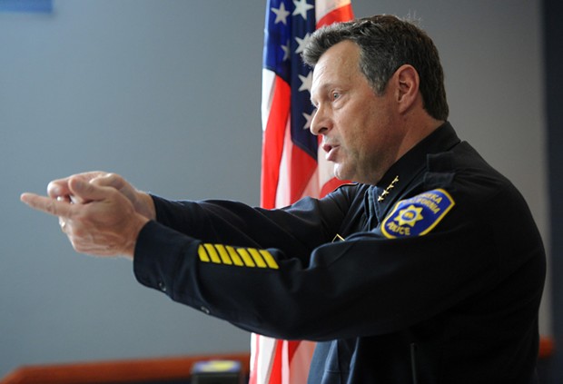 Eureka Police Chief Andy Mills demonstrates how an officer would be holding their weapon while in the "high and ready" position during a press conference on the officer involved shooting of Tommy McCain. - MARK MCKENNA