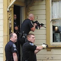 Conflicting Reports Eureka Police officers search for a wanted parolee. Photo by Thadeus Greenson