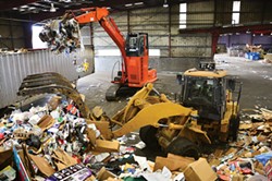 PHOTO BY DREW HYLAND. - Excavators at Humboldt Waste Management Authority's transfer station tops off a trailer with about 16 tons of recyclables. It will travel 142 miles south to be processed at Solid Waste of Willits.
