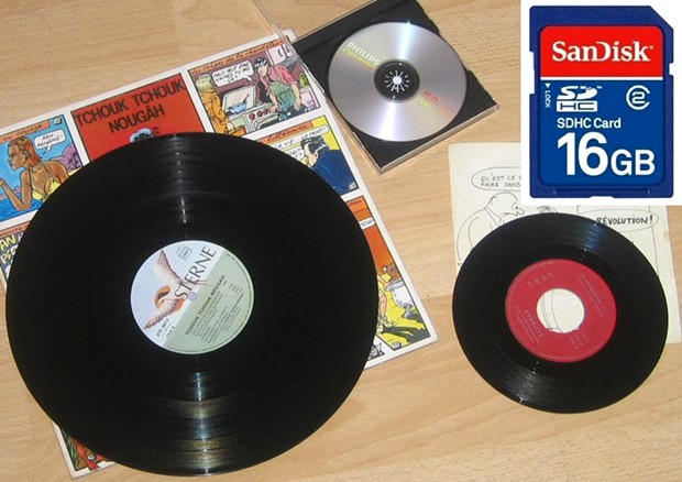 From analog to digital: Introduced in 1949, standard 7-inch 45 rpm vinyl disk has one 3-minute song per side, while 12-inch 33 rpm record holds about 60 minutes/20 songs. 74-minute CD holds 25 songs uncompressed/200 compressed songs. 16 GB chip can store - WIKIMEDIA COMMONS