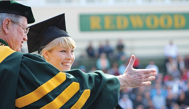 Humboldt State University President Rollin Richmond awards Bryn Robertson her graduate degree at the college's centennial Commencement on Saturday, May 17. - PHOTOS BY BOB DORAN