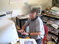 Jack Durham working on his computer at 'The McKinleyville Press.' Photo by Meghannraye Sutton.