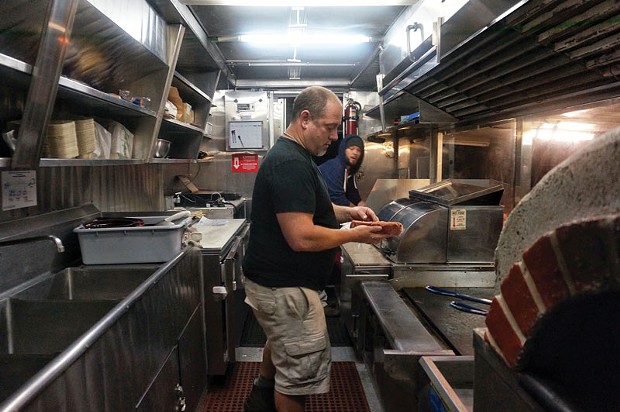 Jason Meyer, owner of Crush, and Shawn Phillips, put out one last order for the night at the brand new food truck, Retro Wagon, parked behind Redwood Curtain Brewery on Friday, July 11. - PHOTO BY BOB DORAN