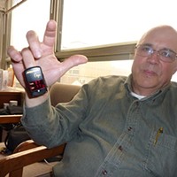Lance Madsen in 2011, showing reporter the oximeter that measures his pulse and blood oxygen.