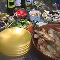 Left: A recent picnic prepared from our new cookbook, Bruschetta, Crostini and other Italian Snacks, by Maxine Clark: Char-grilled bruschetta topped with: olive tapenade, soft eggs, white bean spread, fresh arugula in olive oil, tomatoes, anchovies, red p