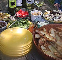Left: A recent picnic prepared from our new cookbook, Bruschetta, Crostini and other Italian Snacks, by Maxine Clark: Char-grilled bruschetta topped with: olive tapenade, soft eggs, white bean spread, fresh arugula in olive oil, tomatoes, anchovies, red p
