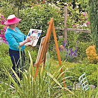 Lynne Wells painting in her garden. Photo courtesy of Redwood Art Association.