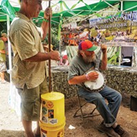 McKinleyville's Raul Lozano plays his homemade gutbucket bass in a jam session at the Kate Wolf Music Festival on Saturday, June 28, at Black Oak Ranch in Laytonville.