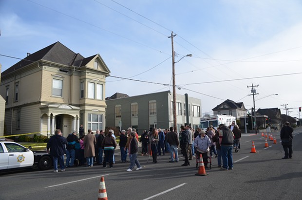 Mourners gather on in front of St. Bernard's church on H and Sixth streets in Eureka. - GRANT SCOTT-GOFORTH