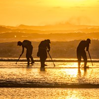 Clam Beach featured a very low tide and a beautiful sunset, plus lots of clam diggers looking for the elusive but very tasty razor clam on Tuesday, Jan. 20. Using a long telephoto lens compressed the distance between the surf line and those looking for clams.