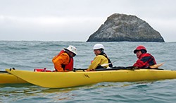 Pilot Rock is the backdrop as Explore North Coast kayak club members David Moore, Larry Buwalda and Mark Lufkin practice rescue techniques near Trinidad. Photo by the Author