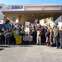 Protesters pose for a group shot outside of Caltrans’ Eureka offices.