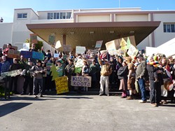 PHOTO BY RYAN BURNS - Protesters pose for a group shot outside of Caltrans’ Eureka offices.