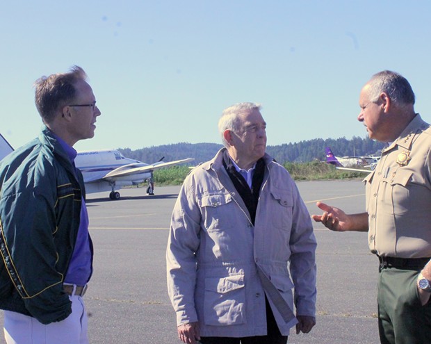 Rep. Huffman (left), news legend Dan Rather and Humboldt County Sheriff Mike Downey chat on the tarmac. - IMAGE COURTESY REP. HUFFMAN'S OFFICE