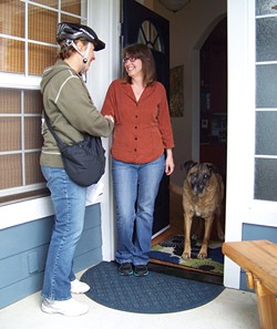 PHOTO BY HEIDI WALTERS - Sharon Latour, knocking on doors, encountered supporter Brenda Pease and dog Suzie.