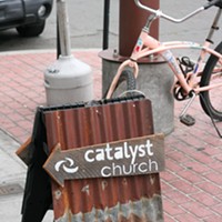 Signs announce a Catalyst Church meeting at Humbrews.