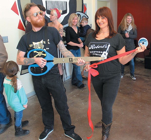 The mandolinist for The Hill,&nbsp;Burly Dent, and his hair cutting partner Nikki Mock prepare to cut the ribbon at their new hair salon in Arcata.