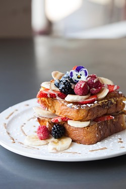 Banana-stuffed French toast with fresh berries at T's. - AMY KUMLER