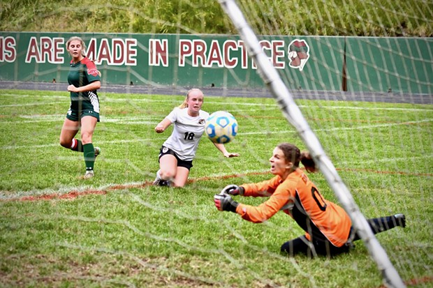 Athena Miller, striker with the Eureka Loggers, watches her kicked ball go into the nets for a goal as Arcata Tiger goalie Sophia Belton stretches out in dismay. - JOSÉ QUEZADA