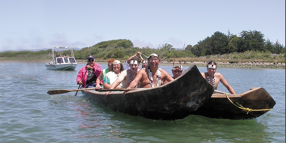 Tribal members in dugout canoes make their way from Indian Island to the Adorni Center for a ceremony marking the return of part of the island to the Wiyots in 2004.