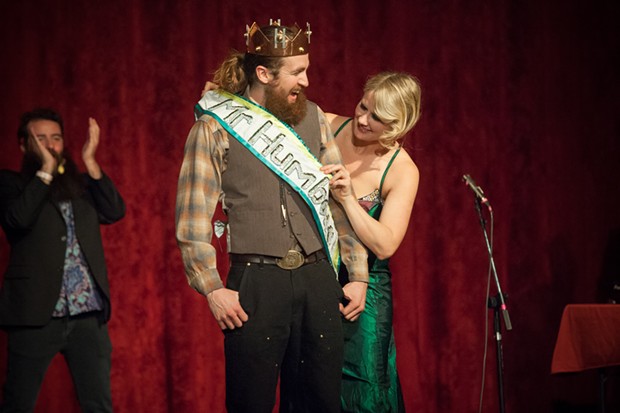 Emcee Johanna Nagan places the sash on Mr. Lumberjack following his crowning as Mr. Humboldt 2019. - PHOTO BY MARK MCKENNA