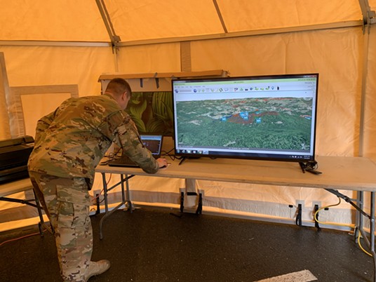 National Guard Staff Sgt. Alan Clark out of Sacramento uses the Nano computer, which uses satellite technology to track search and rescue crews looking for the Carrico sisters. - MARK MCKENNA