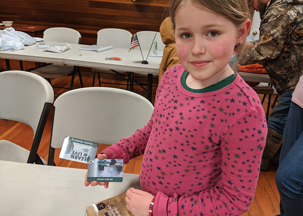 Leia Carrico, one of the two sisters who were lost last weekend, holds a set of flashcards with shelter building advice given to her by her instructor, Jason Lehnert. - MARK MCKENNA