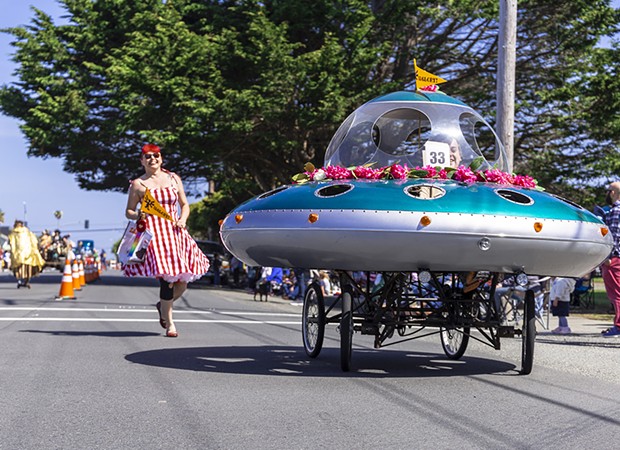 A flying saucer festooned with rhododendrons for the parade. - PHOTO BY SAM LEISHMAN