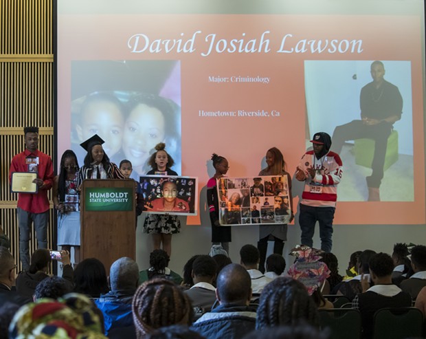 Charmaine Lawson and her family accept David Josiah Lawson's roses at Black Heritage Graduation Celebration. - IRIDIAN CASAREZ