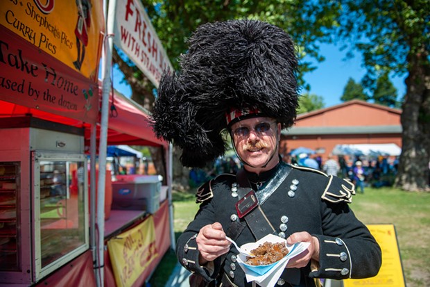 Andrew Endsley enjoys some haggis at the Highland Games on Sunday. - PHOTO BY MARK MCKENNA