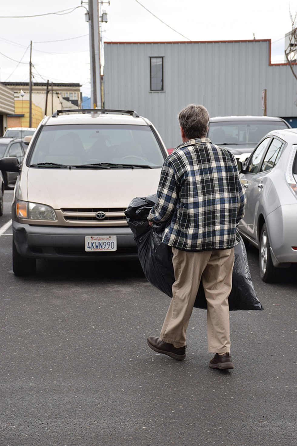 Robert Lohn with a garbage bag full of donated coats picked up from the North Coast Co-op in Eureka - PHOTO BY THADEUS GREENSON