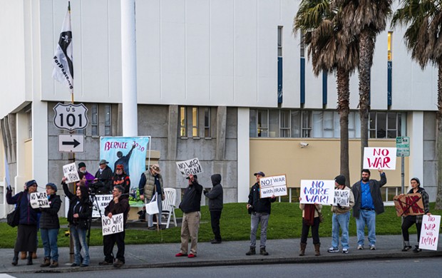 Protesters outside the courthouse elicit honks and shouts from passing cars. - PHOTO BY ZACH LATHOURIS