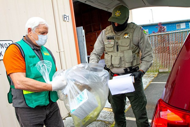 From left, CERT volunteer Cliff Van Cott and Humboldt County Sheriff’s Office Correctional Officer Naveed Ahmed load a distribution van. - COUNTY OF HUMBOLDT