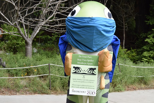 Super Salmon (Zoo mascot) holds one of the new signs to help promote safety around the Zoo. - SUBMITTED