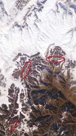 Enlargement of part of a digital photo of Inner Mongolia about 200 miles north of Beijing, taken with a 180 millimeter telephoto lens from the International Space Station in November of 2004. Thanks to fresh snow and bright sunlight, sections of the Great Wall of China can be seen (in red ovals). No astronaut has reported seeing the wall with the naked eye. - IMAGE VIA NASA