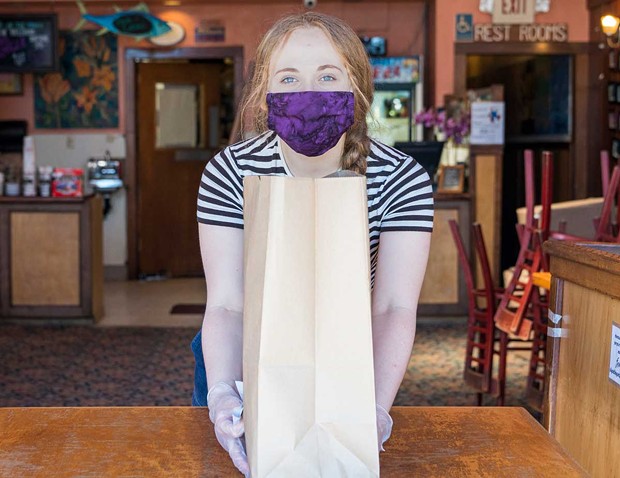 Masked, gloved and good to go at Arcata Pizza and Deli. - PHOTO BY ZACH LATHOURIS