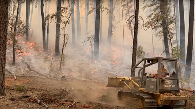A dozer works to slow the spread of fire near Ruth on Sept 28. - MIKE MCMILLAN