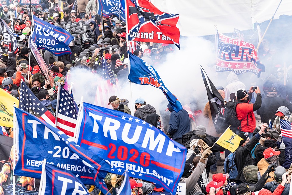 Smoke rises after police used pepper-ball guns against Pro-Trump protesters rallying around the U.S. Capitol before the siege. - LEV RADIN / SHUTTERSTOCK
