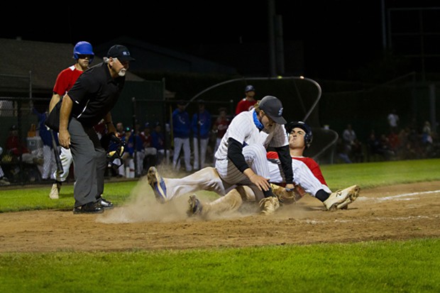 Crabs catcher Andrew Allanson (#22) slides into home to score off of a wild pitch as the Seals Baseball pitcher attempts to tag him out in the bottom of the 8th inning. - THOMAS LAL