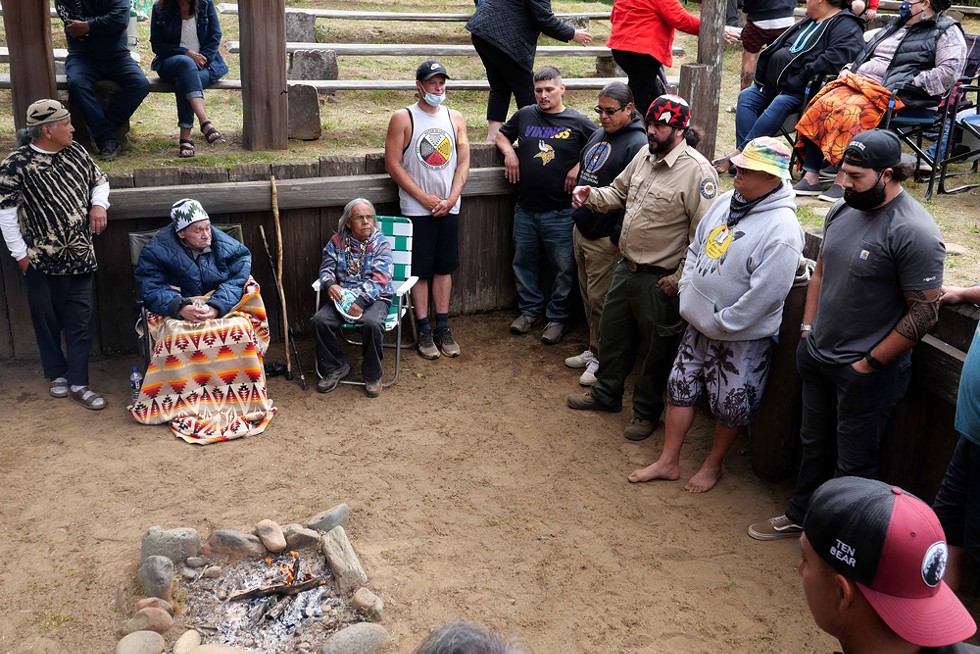Among those honoring Tripp is Yurok State Parks Interpreter Skip Lowry, a friend and student of Tripp's who helped make the event at Sumeg Village happen. - PHOTO BY THOMAS DUNKLIN