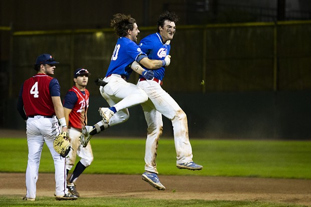 Crabs third baseman David Morgan (No. 20) leaps into the air and hugs teammate Andrew Allanson (No. 22) as he jumps up after hitting the walk-off base hit to win the game against the Redding Tigers in the bottom of the 11th inning on July 20, 2021. - THOMAS LAL