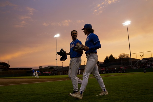 Outfielders Tyler Ganus (Left) and Josh Lauck (Right) head out to take the field as the sun begins to set over Arcata Ballpark on July 27, 2021. - THOMAS LAL