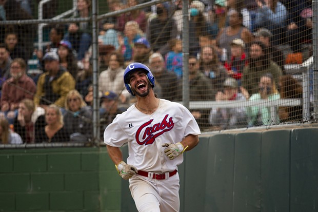 Crabs outfielder Tyler Ganus smiles as he jogs back to the dugout after scoring against the Alaska Goldpanners on August 4, 2021 at Arcata Ballpark. - THOMAS LAL