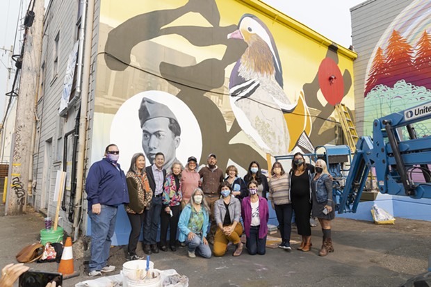 Representatives from mural sponsors Papa & Barkley, as well as the city of Eureka, join artists Dave Kim and Cate Be posing with Mary Chin, widow of Ben, and their youngest son Don, with ECP members Alex Ozaki-McNeill, Patty Hecht and Brianne Mirjah D’Souza, and Jean Pfaelzer in front of the completed mural “Fowl.” - PHOTO BY ALEXANDER WOODARD