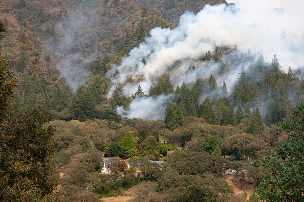 Smoke rises from the Six Rivers Lightning Complex Fire as it burns near the Cavaletto Vineyard Estate across the river from State Route 299 near Willow Creek California. - MARK MCKENNA