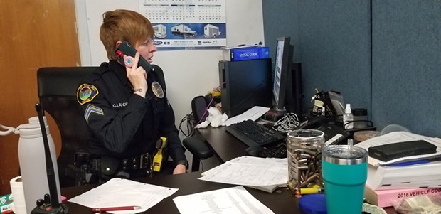 Rio Dell Police Department Cpl. Crystal Landry works the phone, trying to find a suspect in a property crime. - PHOTO BY LINDA STANSBERRY